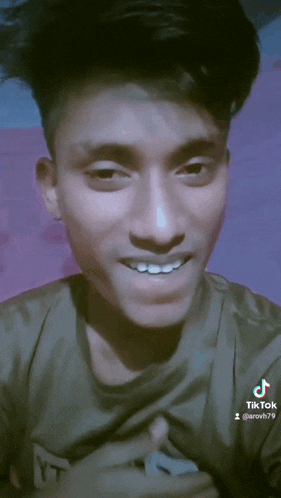 a close up of a young man 's face with tiktok written on the bottom right corner