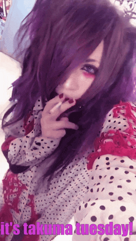 a woman with purple hair is taking a selfie with the words it 's takuma tuesday below her
