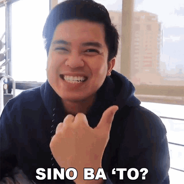 a man is smiling and giving a thumbs up with the words sino ba to written below him