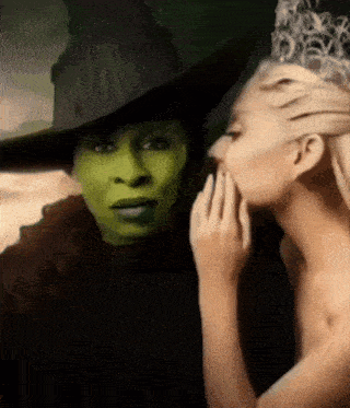 a woman whispering into a witch 's ear
