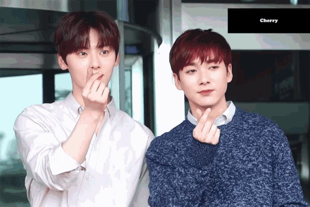two young men are making hearts with their hands and the word cherry is visible in the corner