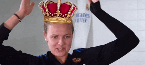 a woman wearing a crown on her head with a shirt that says " rates better " behind her