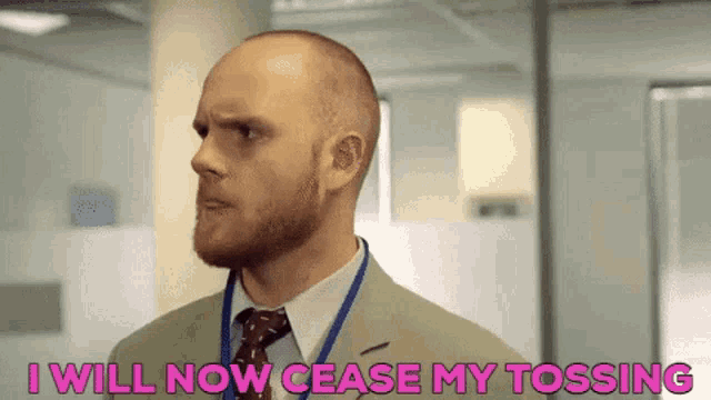 a bald man with a beard is wearing a suit and tie and says i will now cease my tossing .