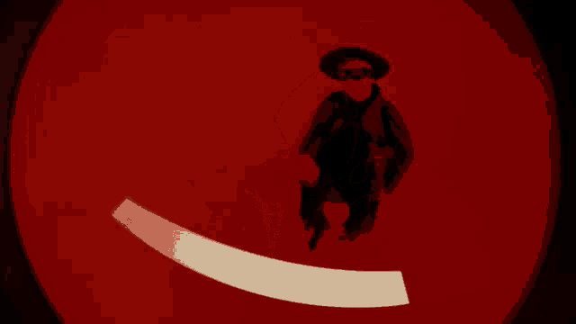 a person wearing a mask is laying on a red background