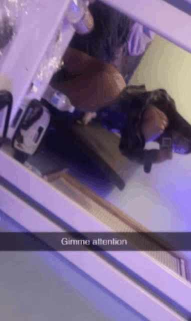 a person is taking a selfie in front of a mirror with the words gimme attention written on the bottom