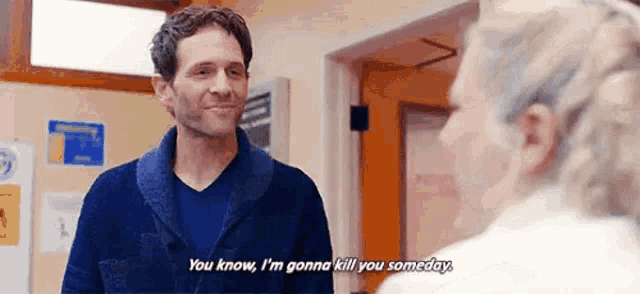 a man is talking to an elderly woman in a room .
