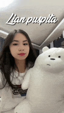a girl holding a stuffed polar bear with the name lian puspita on the bottom right