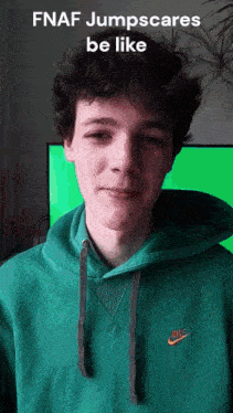 a young man wearing a green nike hoodie