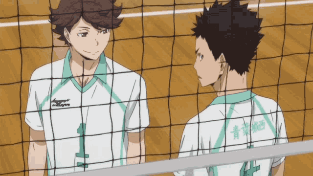 two volleyball players wearing mizuno jerseys are standing next to each other