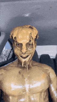 a man in a car with his face covered in melted peanut butter