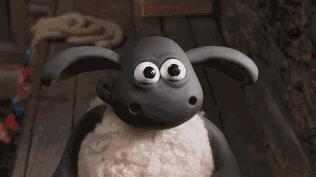 a sheep in a sweater is holding a christmas present