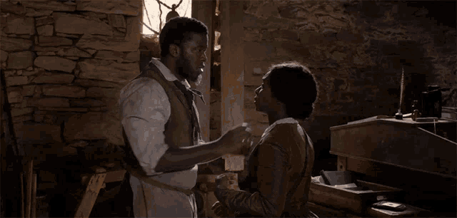 a man and a woman are hugging each other in a room