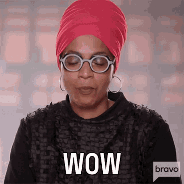 a woman wearing glasses and a red turban says wow on bravo