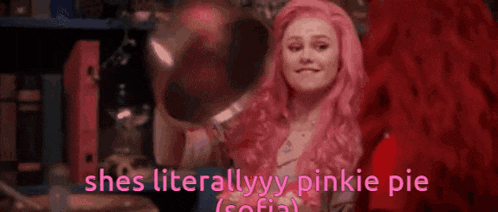 a woman with pink hair is holding a bowl in her hand and says `` she 's literally pinkie pie '' .