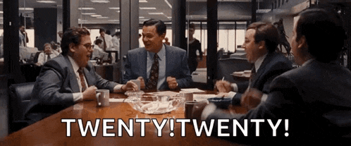 a group of men are sitting around a table with the words twenty twenty written above them