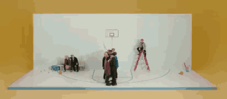 a group of people are playing basketball in a circle .
