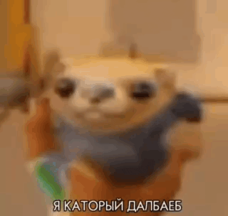 a person is holding a stuffed animal that looks like a sloth in their hand .