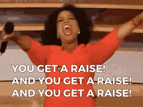 a woman in a red dress is holding a microphone with her arms in the air and says " you get a raise "