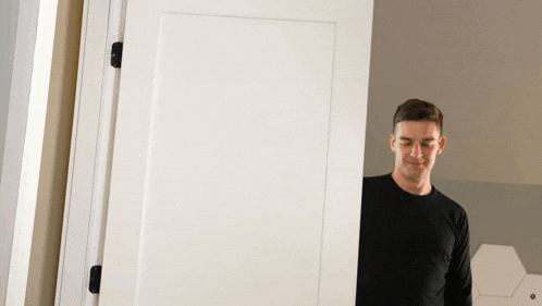 a man standing in front of a white door