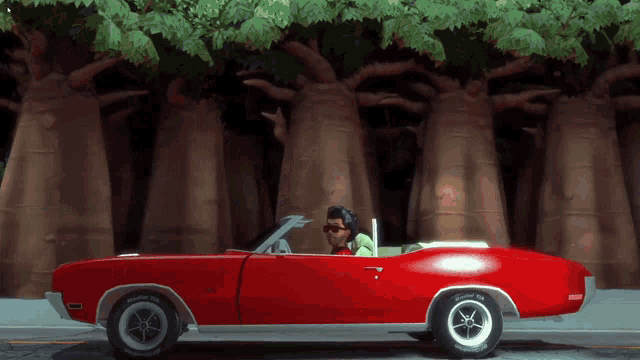 a man is driving a red car with bfgoodrich tires on it