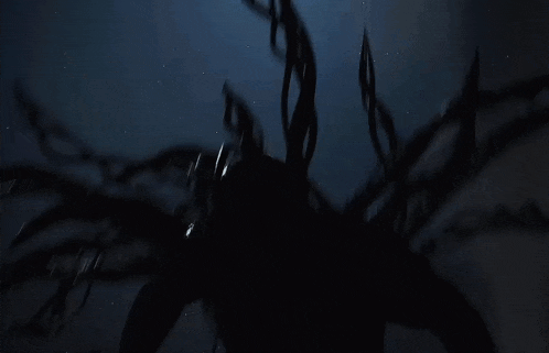 a silhouette of a monster in the dark with a lot of tentacles