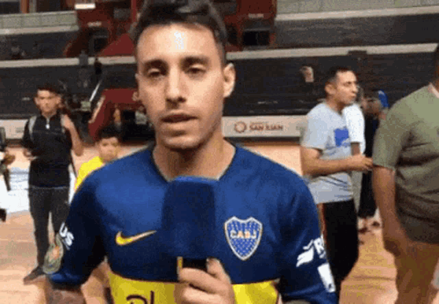 a man wearing a blue and yellow jersey that says cabj