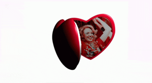 a picture of a woman in a red dress is on a heart shaped item
