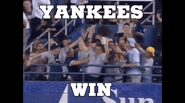 a crowd of yankees fans are celebrating their win