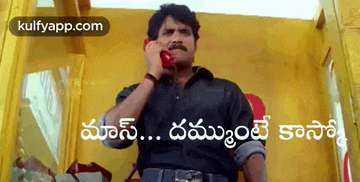 a man is talking on a phone in a yellow booth with a caption in a foreign language .