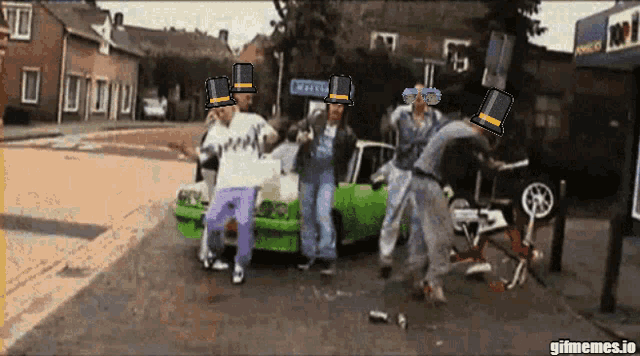 a group of people are dancing in front of a green car and a sign that says ' gifmemes.io ' on it