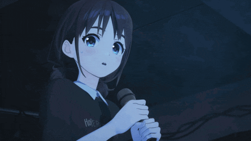 a girl with blue eyes is singing into a microphone in the dark