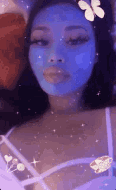 a woman with a blue mask on her face and a butterfly in her hair .