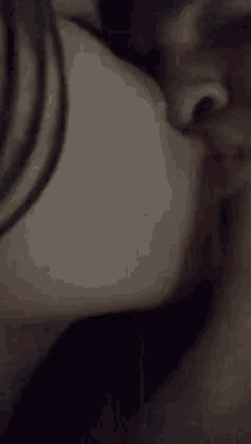 a close up of a person kissing another person 's nose .