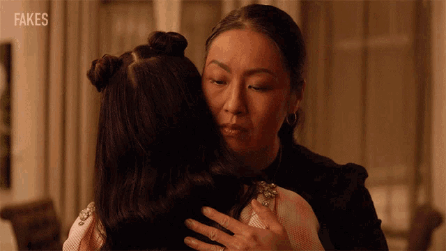 two women hugging each other with fakes written in the corner