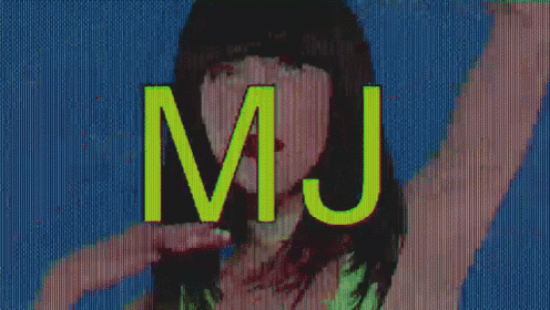a woman wearing a black hat is making a peace sign in front of a screen that says mj