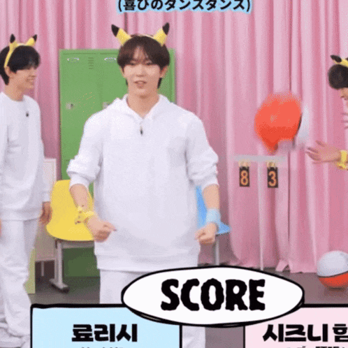 a man wearing a pikachu headband stands in front of a sign that reads score