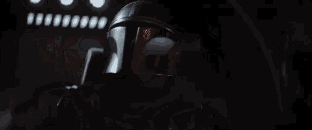 a close up of a person in a helmet in a dark room .