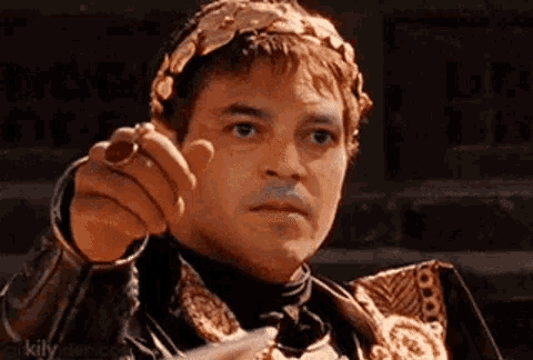 a man with a laurel wreath on his head is pointing