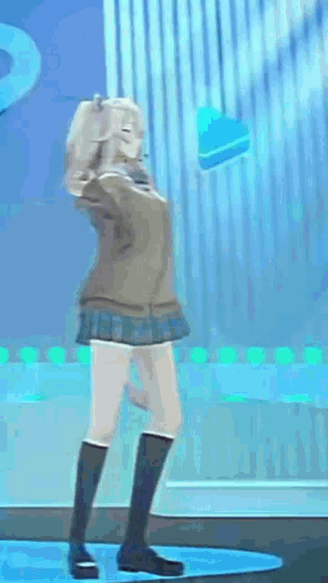 a girl is dancing on a stage in a video game .