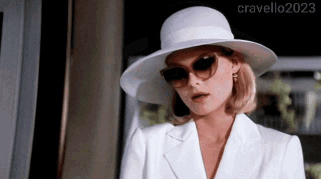 a woman wearing a white hat and sunglasses has the year 2023 on the bottom left