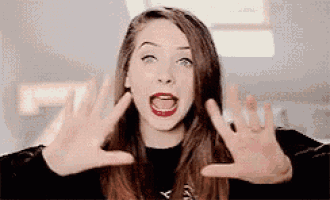 a woman is making a funny face with her hands in the air .