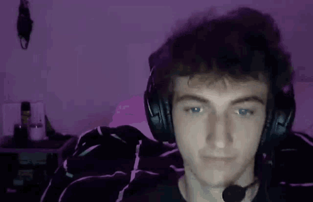 a young man wearing headphones and a microphone .