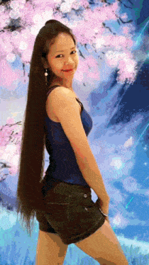 a woman with long hair is standing in front of a painting of a cherry blossom tree