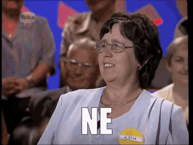 a woman with glasses and a name tag that says alena is smiling