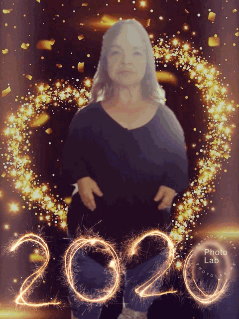 a woman is surrounded by sparklers and the year 2020