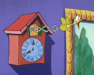 a cuckoo clock with roman numerals and a duck hanging from it