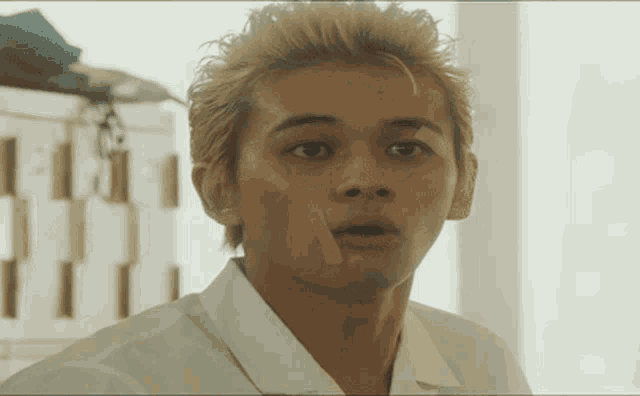 a young man with a bandage on his face