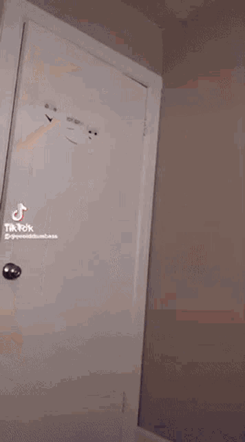 a tik tok video of a person opening a white door