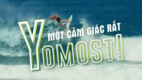 a man is riding a wave with the words yomost written above him