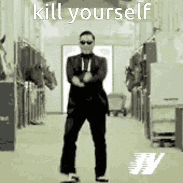 a man in a suit and tie is dancing in a hallway with the words kill yourself written above him